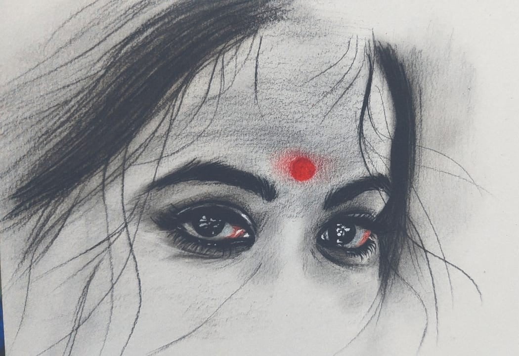 Charcoal drawing of eyes with a red bindi